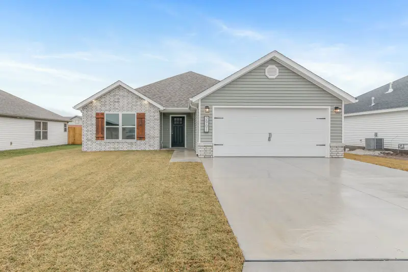 White ranch home with a white two-car garage door